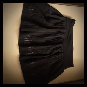 A black ivivva skirt with a functional zipper